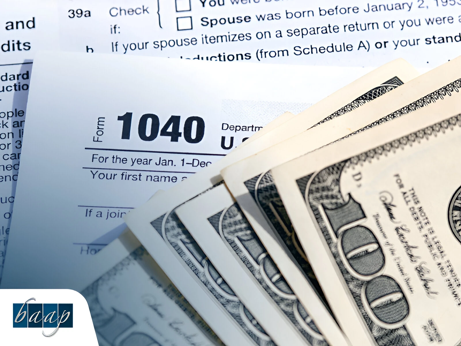 Close-up of 1040 tax document and US currency used in tax preparation